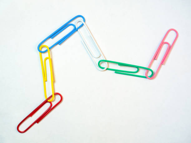 istock Large multi-colored paper clips. Paperclip of documents. Desktop. 1394950432