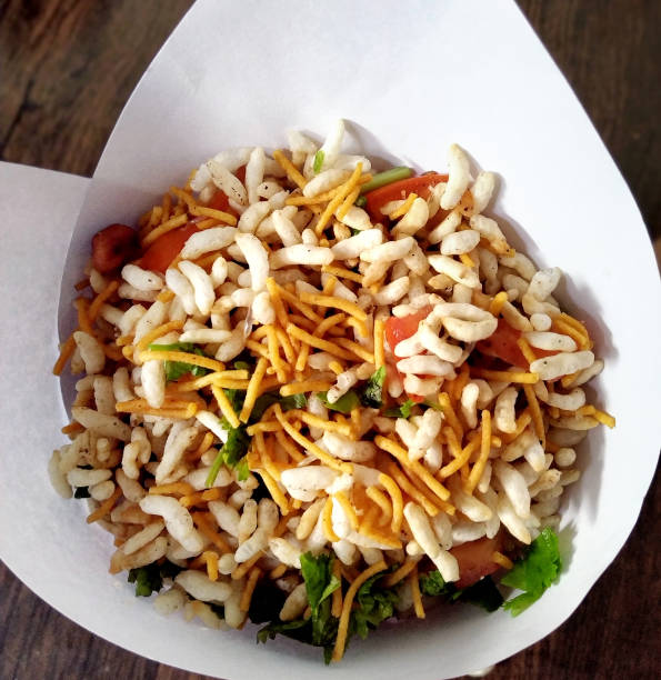 istock Bhel poori, an Indian road side snack in a conical shape paper container 1394951809