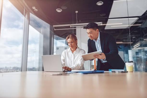 istock Business people in office meeting for project and discuss it using laptop and tablet 1394952033
