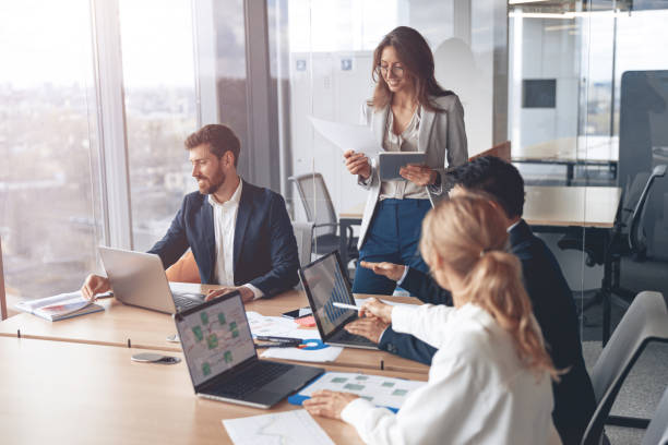 istock Young Businesspeople Working with Laptop in Office. Communication and Discussion at Work Concepts 1394952065
