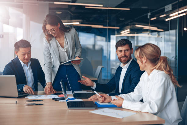 istock Woman explaining her ideas to colleagues in conference room at modern office 1394952084