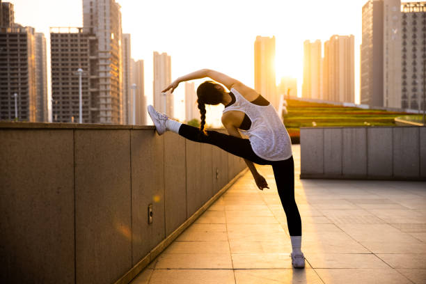 istock Young woman stretching before jogging in the morning 1394958430