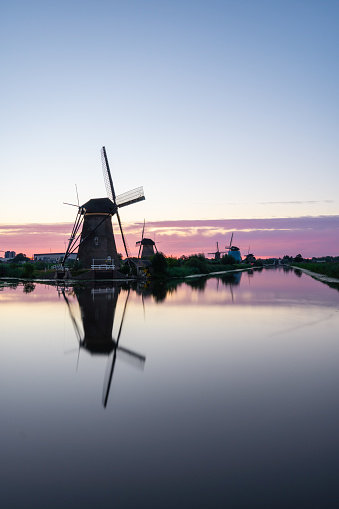 Netherlands windmills during sunset with reflection.