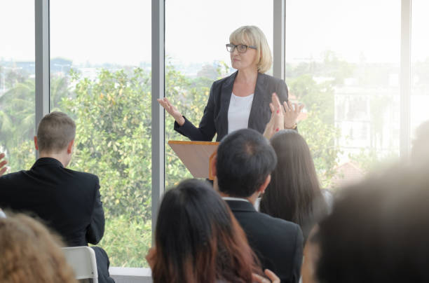 istock Senior businesswoman making speech 1394964183