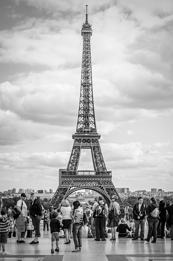 Paris, France - September 14, 2011: People in Trocadero Square in Paris and The Eiffel Tower in the background. Black and white urban photography