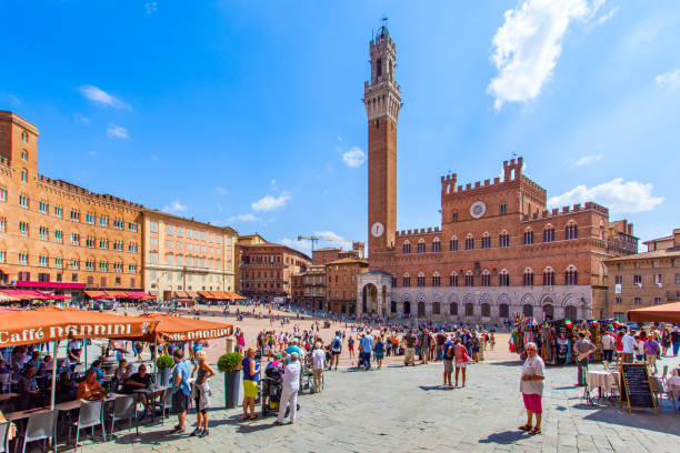 People in Piazza del Campo in Siena Siena, Italy - September 6, 2014: People in Piazza del Campo square in Siena torre del mangia stock pictures, royalty-free photos & images