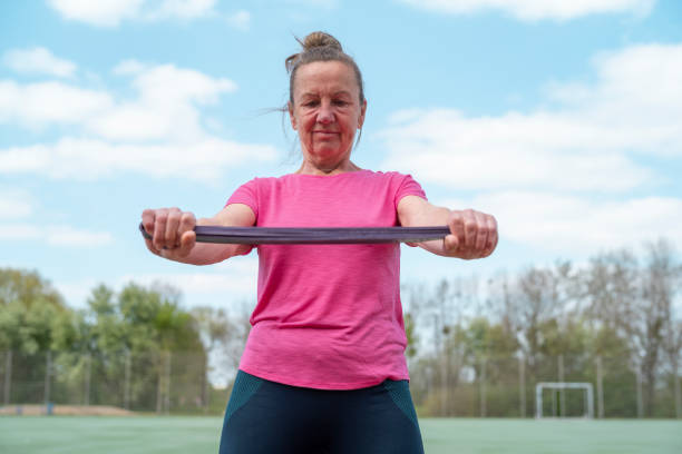 istock Senior woman doing doing exercises rubber band. 1394965670