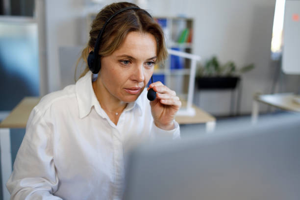 istock Female call center agent with a headset works on the support hotline 1394965725