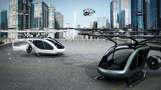 Conceptual eVTOL (electric vertical take-off and landing) aircrafts as a taxi/shuttle service at the helipad on top of a building.