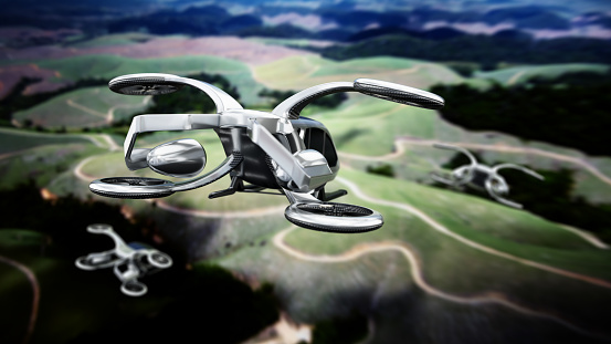 Conceptual eVTOL (electric vertical take-off and landing) aircrafts flying over rural areas.