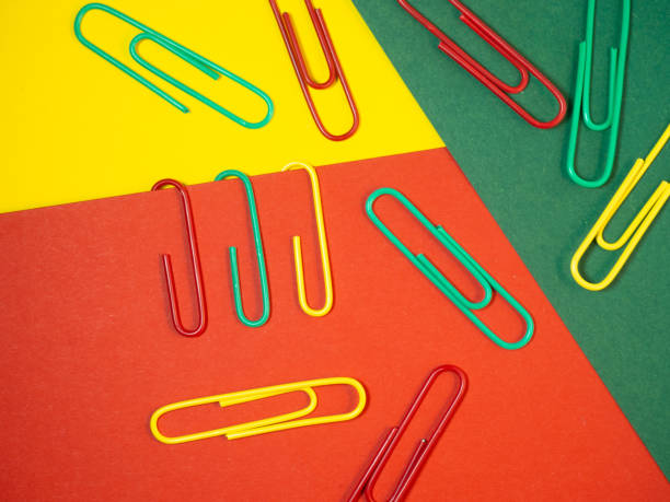 istock Large multi-colored paper clips. Paperclip of documents. Desktop. 1394968981