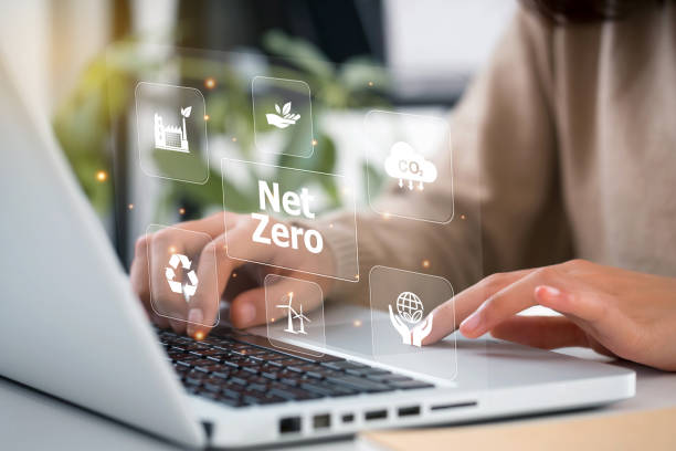 istock women hand using laptop for working technology and business Net zero and carbon neutral concept.NET ZERO icons and symbols save the eco world and reduce pollution. greenhouse gas emissions target. 1394969670