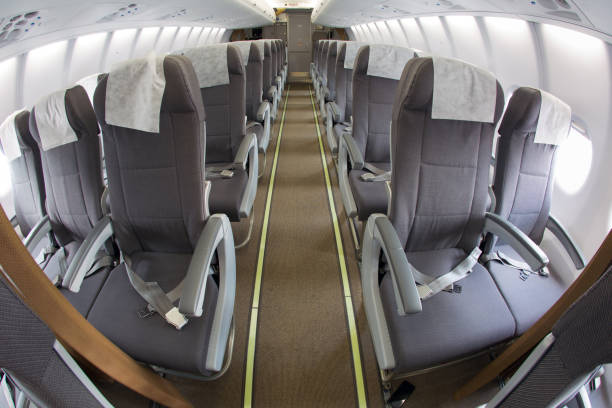 istock Cabin of modern passenger airplane. Aisle between seats. 1394969726