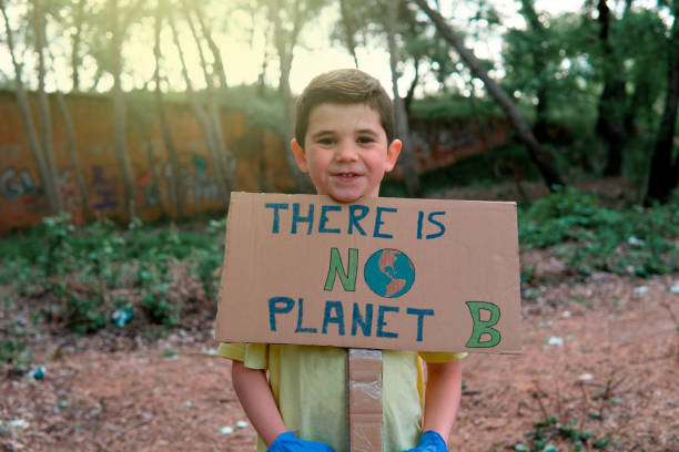 istock Boy with sign that says there is no planet b 1394972608
