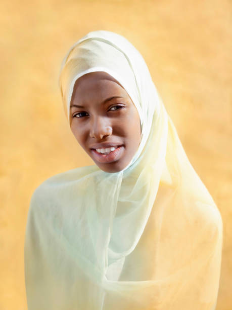 istock Young Afro beauty wearing a veil, beige background 1394975017