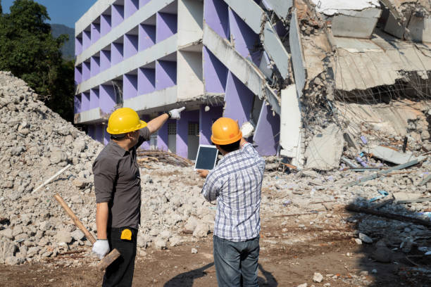 istock Demolition control supervisor and foreman discussing on demolish building. 1394975325