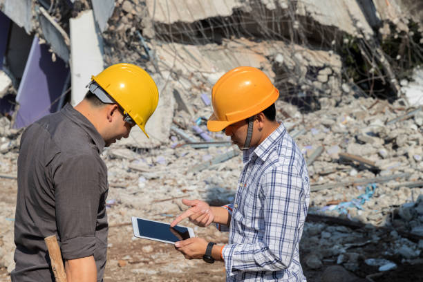 istock Demolition control supervisor and foreman discussing on demolish building. 1394975334