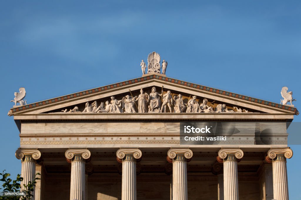 Academy of Athens - the pediment representing the birth of goddess Athena The pediment of the entrance to the Academy of Athens. It consists of a multiple-figured composition representing the birth of goddess Athena. It is a work of the sculptor Leonidas Drosis (1843-1884). Zeus Stock Photo