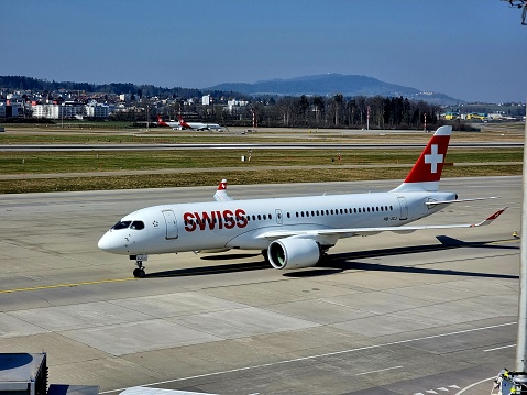 HB-JCI SWISS AIRBUS A220-300 aircraft at the Airport in Zurich (ZRH). The image was captured during spring season.
