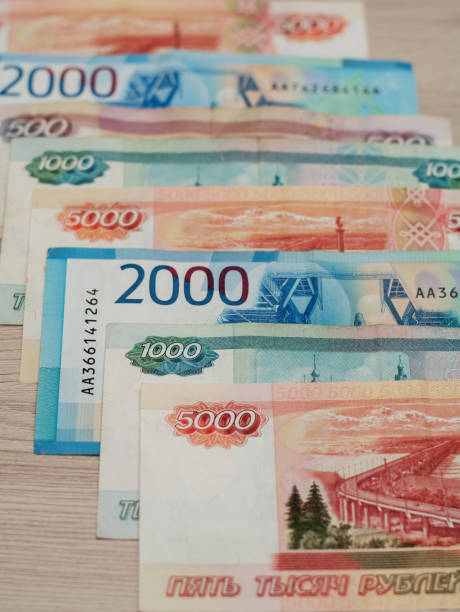 istock Row of various russian banknotes on  wood background. 1394976054