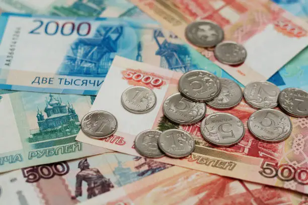 Close-up Russian banknotes and coins with a nominal value of 1,2 and 5 rubles. Banknotes with the inscription 1, 2 and 5  thousand rubles and 500 rubles.
Money background. 
Focus on one rubles
