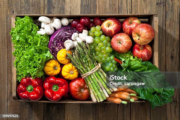 Crate Full Of Fruits And Vegetables Over Rustic Table Stock Photo - Download Image Now