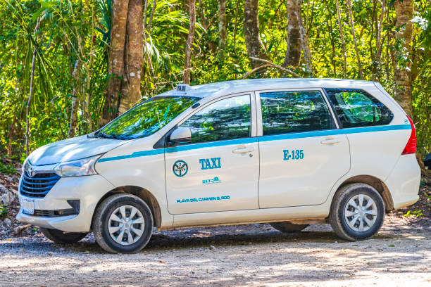 Taxi car in tropical natural jungle Playa del Carmen Mexico. Puerto Aventuras Mexico 04. February 2022 White van car taxi in tropical mexican jungle plants trees and natural forest panorama view and walking path in Playa del Carmen Mexico. puerto aventuras stock pictures, royalty-free photos & images