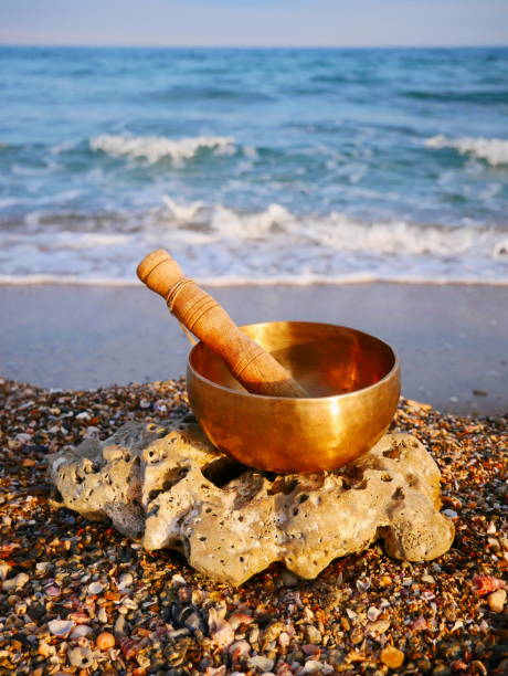 istock Singing bowl set on a pebble beach with the sea in background 1394976697