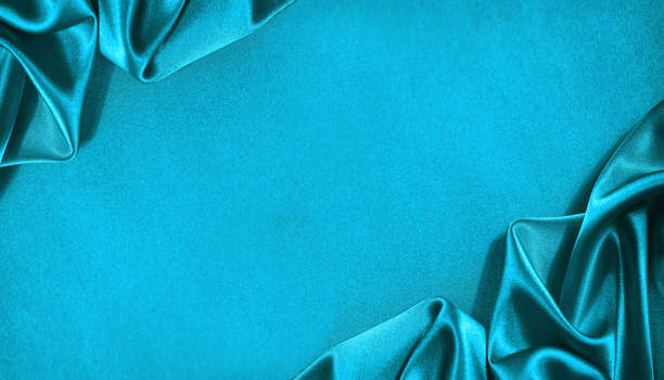 istock Beautiful light green blue silk satin surface. Soft folds on shiny fabric. Luxury teal background with space for text, design. Web banner. 1394977430