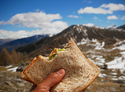 Beautiful photo of a hiker's sandwich with the snow-covered mountain in the background