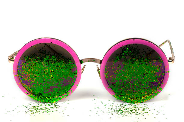 Glamorous sunglasses with green sparkles on a white background.