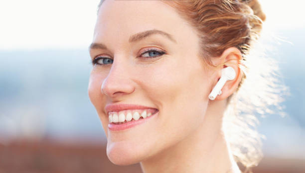 istock Redhead woman calling by hands free device closeup 1394981792
