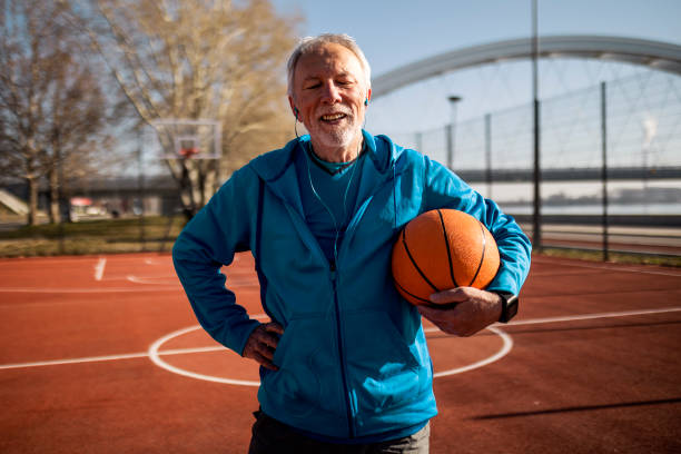 istock Senior taking a break on a basketball court posing looking at camera 1394983561