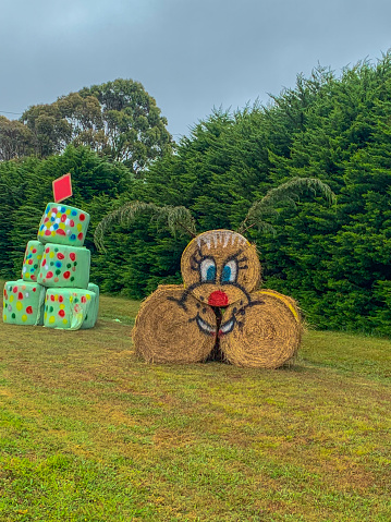 Victoria, Australia - December 14, 2019: Hay bales with graffiti at a farm beside Princes highway in Victoria, Australia.