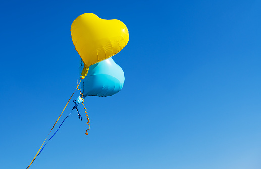 balloons blue and yellow against a blue sky