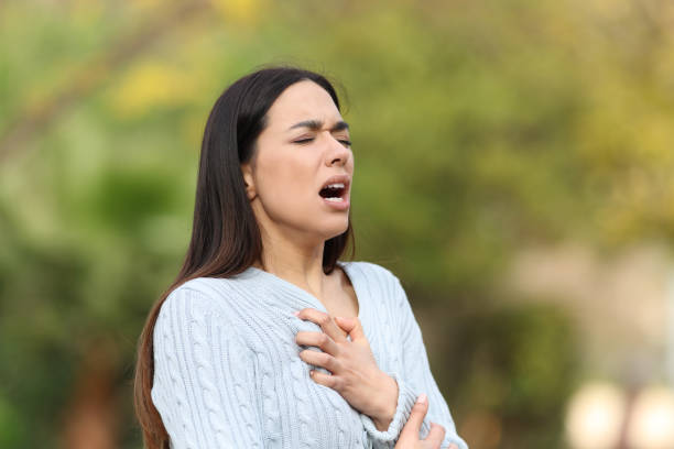 Woman having breath problems in a park Woman having breath problems in a park anaphylactic shock. stock pictures, royalty-free photos & images