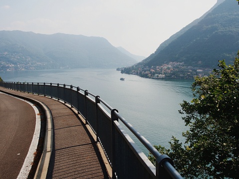 A road and a view over Lake Como