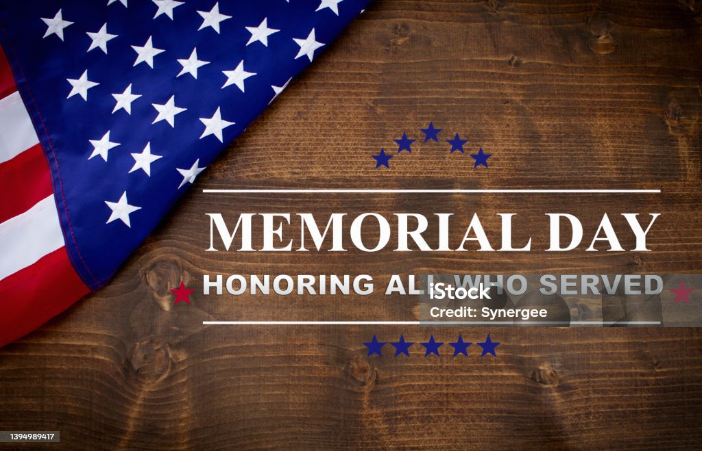 Memorial Day Memorial Day written on a dark wood background, with an American flag. US Memorial Day Stock Photo