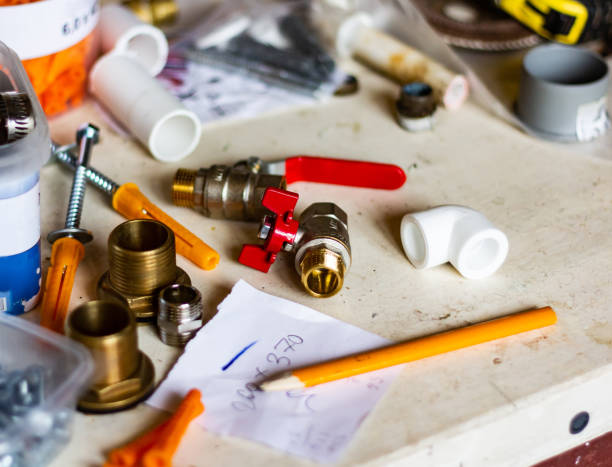 istock Plumbing tools, screws and pipes on a working desk 1394989580