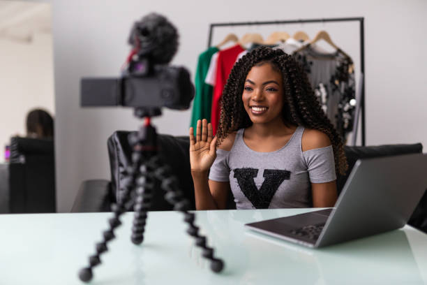 istock Young black woman working as blogger, recording video tutorial for Internet 1394993091