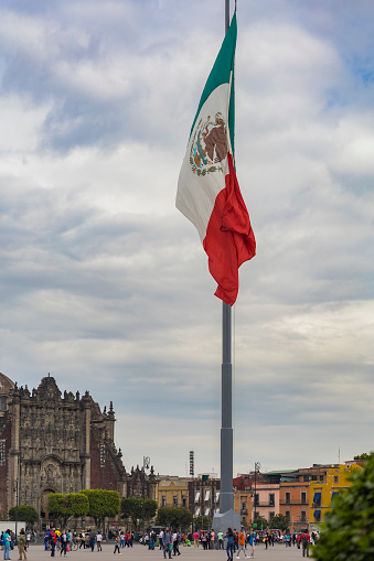 Mexico City, CDMX, Mexico, OCT, 24 2021, Large flagpole with the flag of Mexico flying in the Zócalo square