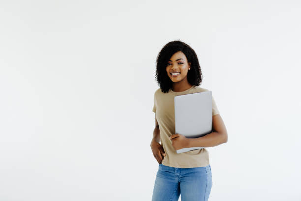 istock Happy afro woman using laptop isolated over white background 1394993457