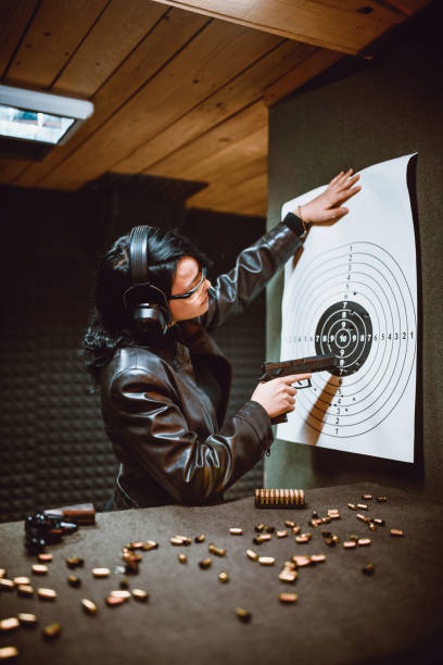 istock Female Examining Shooting Results Gun Range Target 1394993687