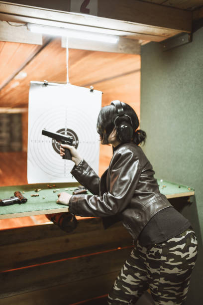 istock Female Shooter Ready To Send Target Far For Precision Shooting Practice 1394994295