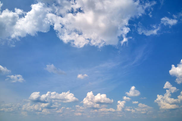 istock Bright landscape of white puffy cumulus clouds on blue clear sky 1394994484