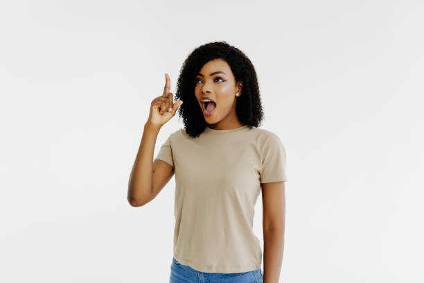 istock Young African woman isolated on white background pointing up a great idea 1394994800