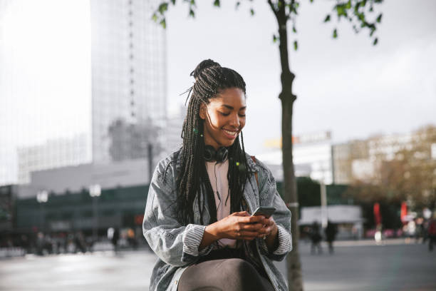 istock Young woman in Berlin texting on mobile 1394997094
