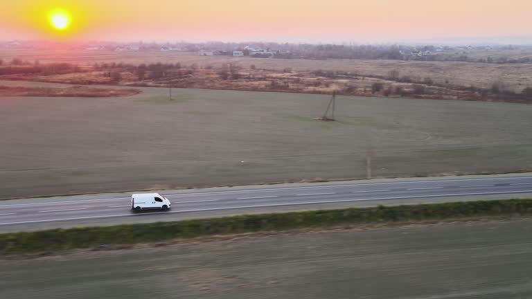 Aerial view of cargo van driving on highway hauling goods. Delivery transportation and logistics concept