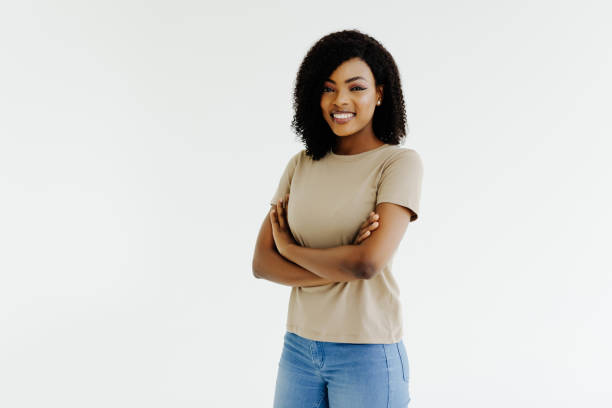 istock Joyful African student keeps hands crossed, isolated over white background. 1394998301