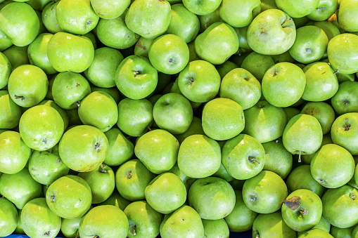 Full frame of green fresh organic farmer’s apples background